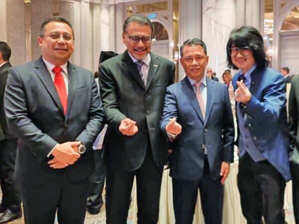 Distinguished guests pose for a photo with Prof. Mike Chan during the prestigious National Day celebration at the JW Marriott Hotel.