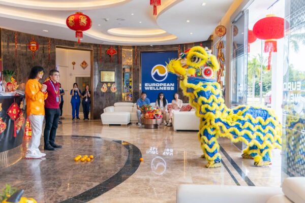 Professor Chan shares a moment with the lion dancers, reflecting the spirit of community and tradition.